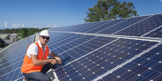 worker installing roof integrated solar photovoltaic panels portfolio